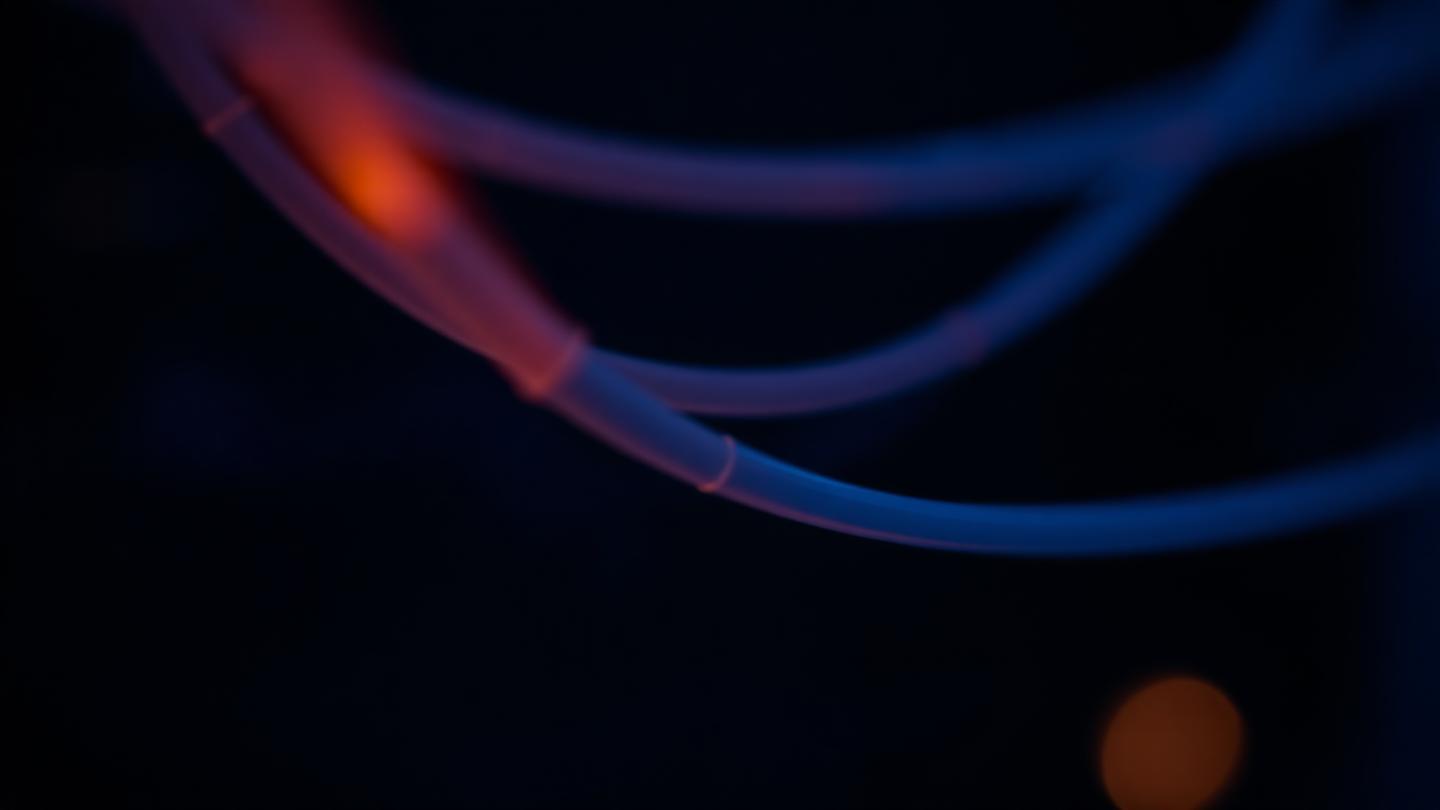 Glowing optical fibers symbolising digital infrastructure and regulated data flows.